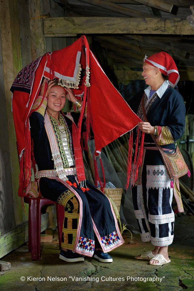 Ly Ta May is the oldest of three sisters. She is twenty-four years old.   Her mother, Cheo, kindly helped Ly demonstrate putting on her wedding dress that was handed down from mother to daughter. The Red Dao wedding dress is seen as the summit of success in a women’s sewing accomplishments. Mother and daughter are known to spend up to a year making nothing else but a brand-new ceremonial outfit in preparation for the big day.