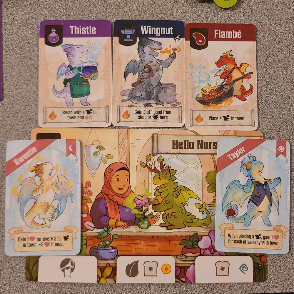 A sampling of different types of cards from the board game Flamecraft, each featuring cute illustrations of little dragons engaging in potion-brewing, tailoring, cooking, and other professions.