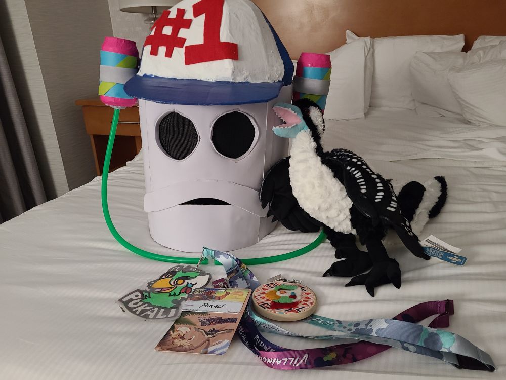 My badges mixed with my Smitty cosplay head and plush dino bird child.