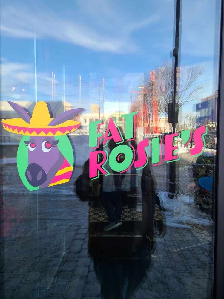 Front door logo for a Rosemont Mexican restaurant called Fat Rosie's. The titular Rosie is cute cartoon donkey girl wearing a Sombrero and with heart eyes