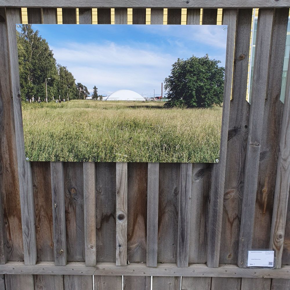 A photo print on a fence. Heinäpää Photowalk open-air exhibition at Oulu, Finland.