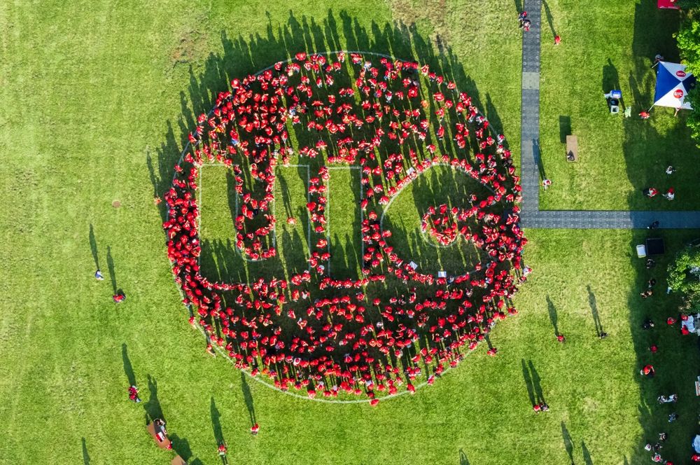 students wearing red shirts gathering in the shape of the University of Illinois Chicago's logo