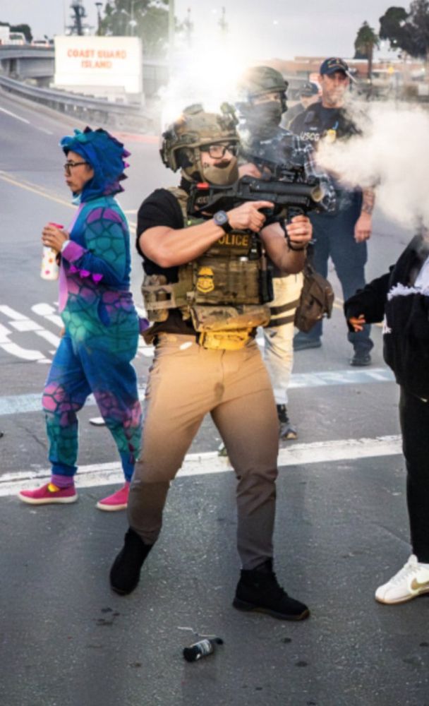 Federal agent with a wet spot in his pants while firing a grenade.