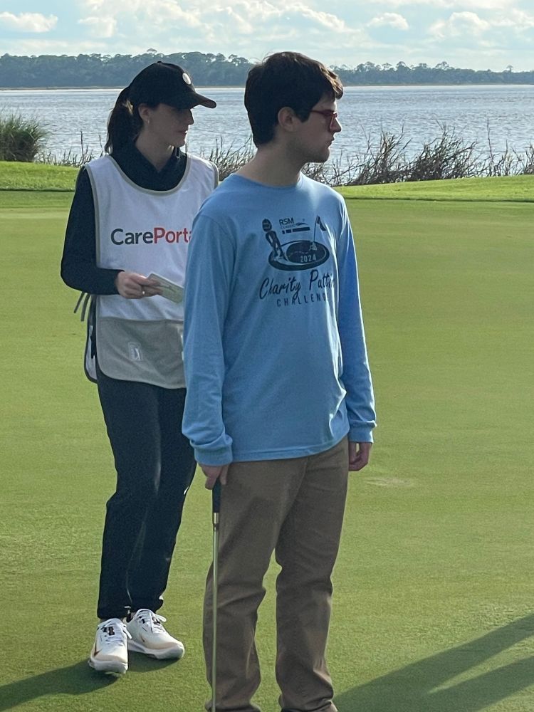 Caitlin Clark caddying for Special Olympics athlete.