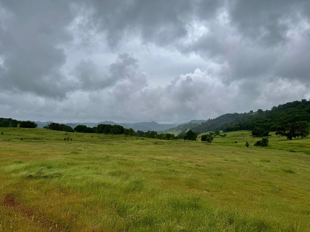 Clouds and rolling green hills