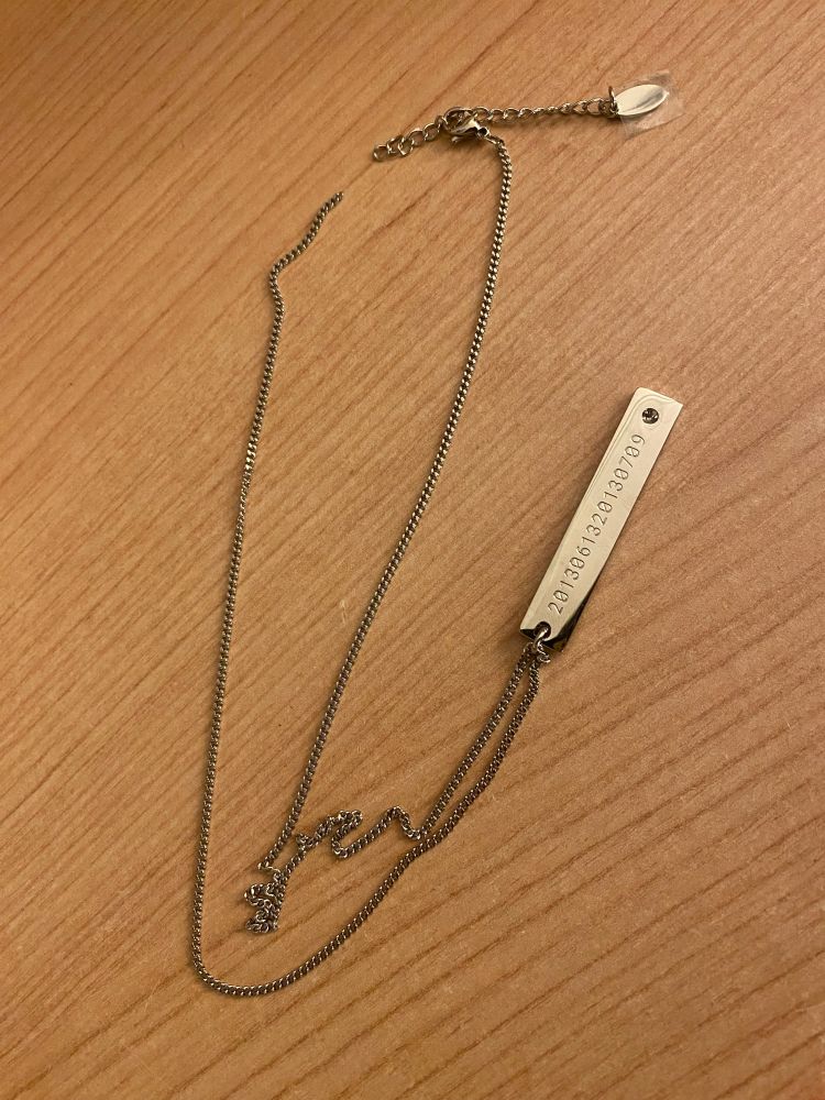 A broken necklace of BTS' MNCR merch