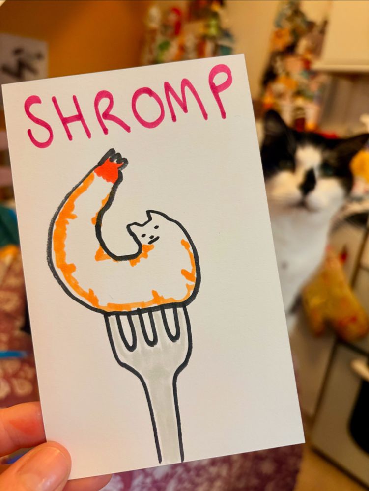 A drawing of a shrimp on a fork but it has got a little cat head 