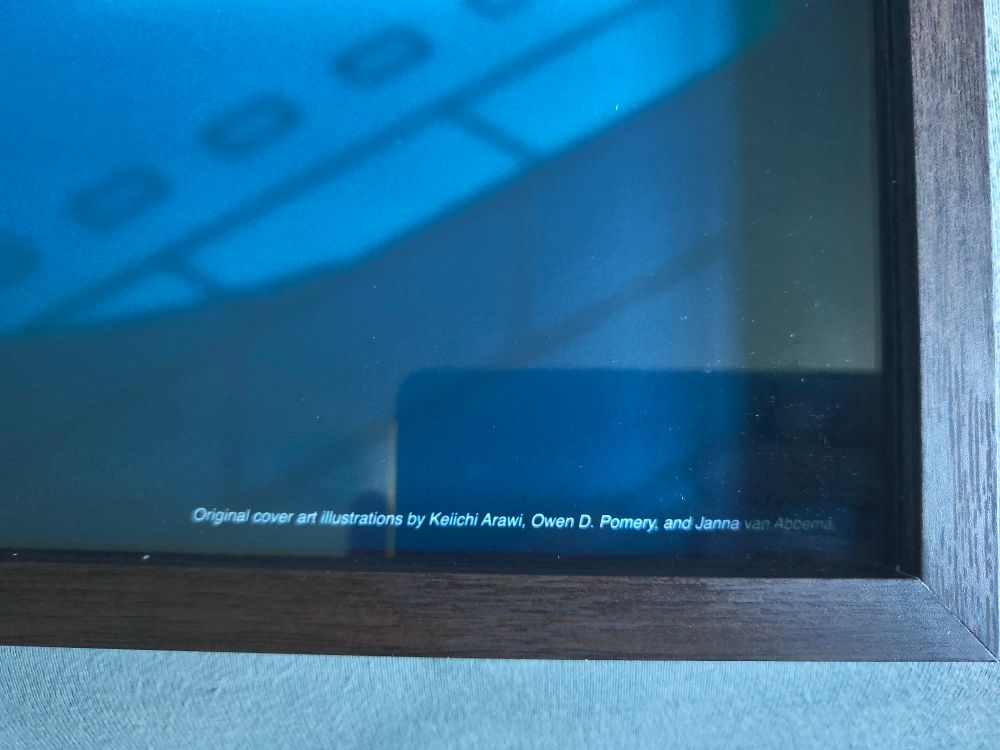 A picture of the bottom right corner of the frame, text reading: "Original cover art illustrations by Keiichi Arawi, Owen D. Pomery, and Janna van Abbema."