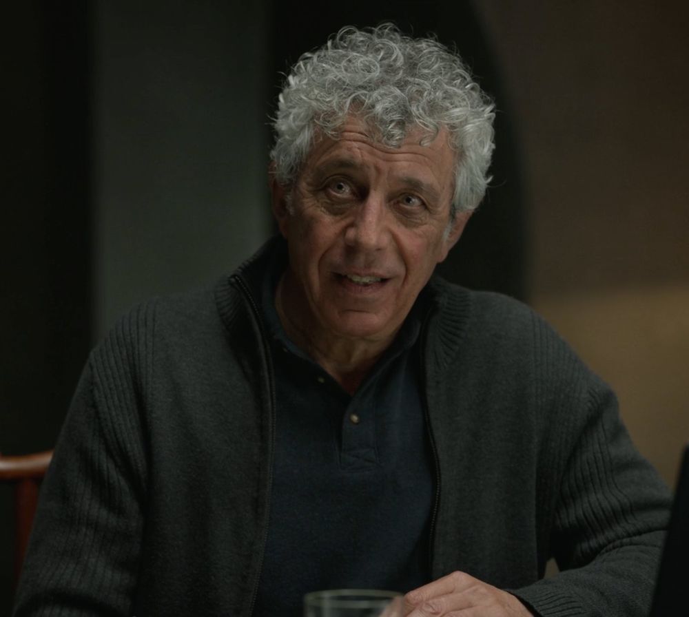 Same scene, but Daniel's awkward smile has faltered. His expression is nervous; what DID happen in San Francisco?