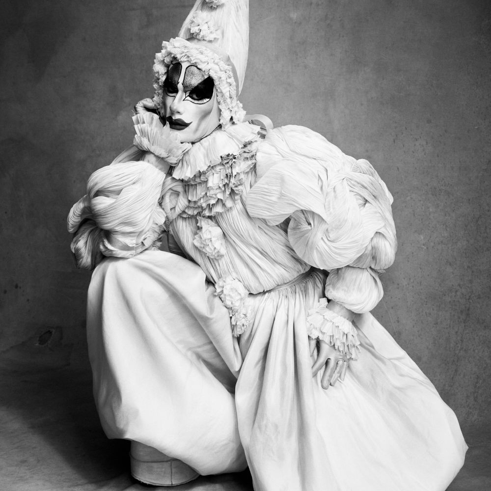 Black and white photograph by Victor Demarchelier of Tillie the Clown in a hand pleated clown suit by Corvus + Crux, made for the Whitney Museum's 2024 tribute to Edward Hopper, "Step Into Hopper".