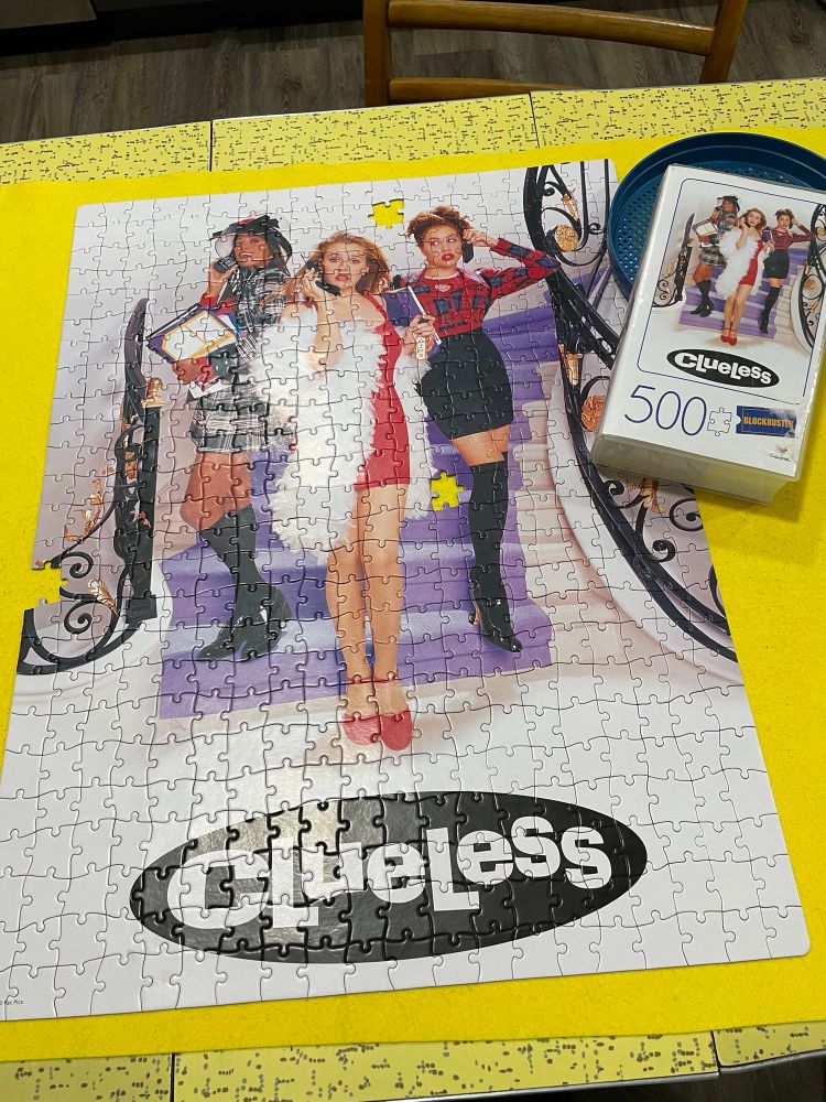 Clueless ( a movie from 1996 ) poster art in puzzle form. The box it comes in is shaped like a Blockbuster videotape. 