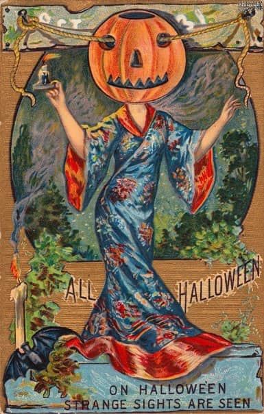 A greeting card from around 1910, with a picture of a lady in a fancy dress with a giant pumpkin for a head. A rope runs through the eyes of the pumpkin.  Also visible are a bat with wings spread and a candle from which wisps of smoke pervade the scene.  Below is written "On Hallowe'en, strange sights are seen"