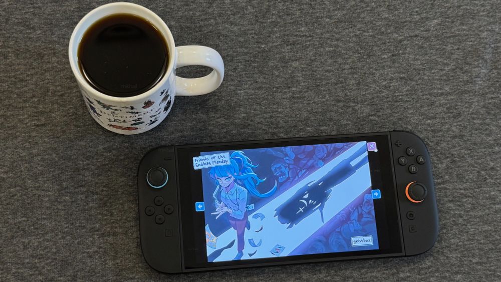 Endless Monday by hcnone on Switch 2 next to a cup of coffee. The art on screen is by Geistbox. 