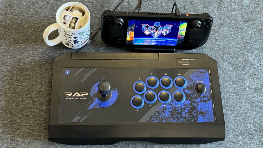 Earthion on Steam Deck connected to a Hori Rap V Hayabusa next to a Pentiment mug with cold brew coffee. Read my review here: https://www.patreon.com/posts/earthion-review-136235775