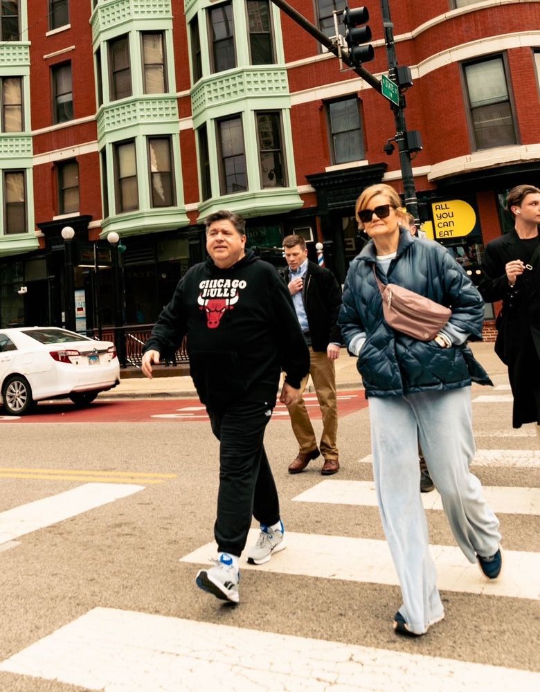 Illinois Governor Pritzker looking fit crossing at the crosswalk in April, 2025. 