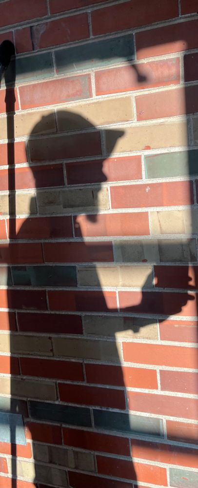 Profile shadow of man on brick 