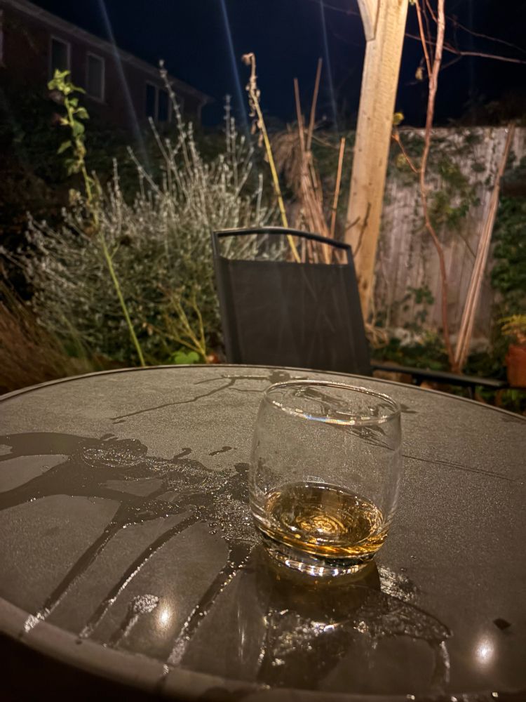 A glass of whisky on a cold patio.