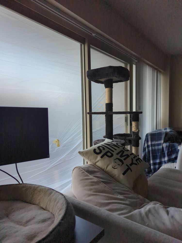 Apartment windows covered in plastic