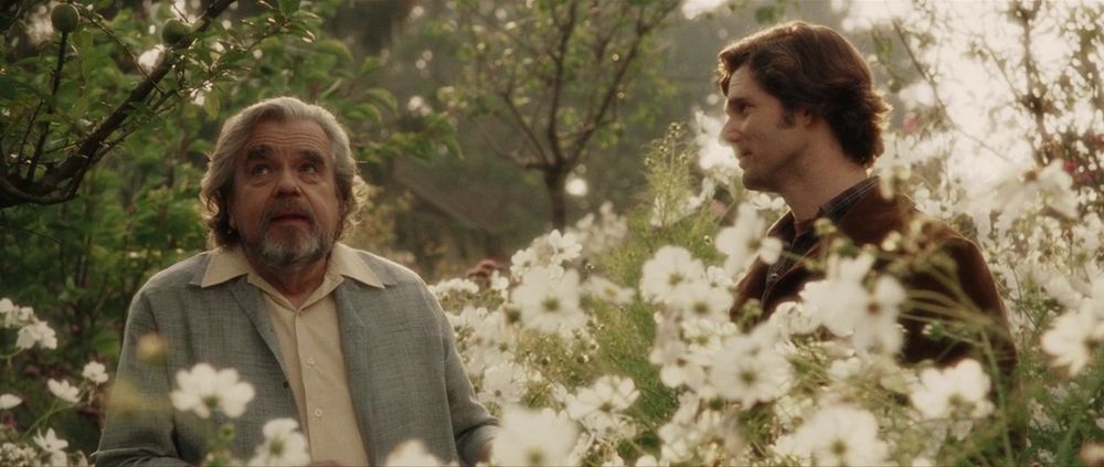 Michael Lonsdale and Eric Bana in a field of flowers in the exact mid-point sequence in MUNICH (Spielberg, 2005)