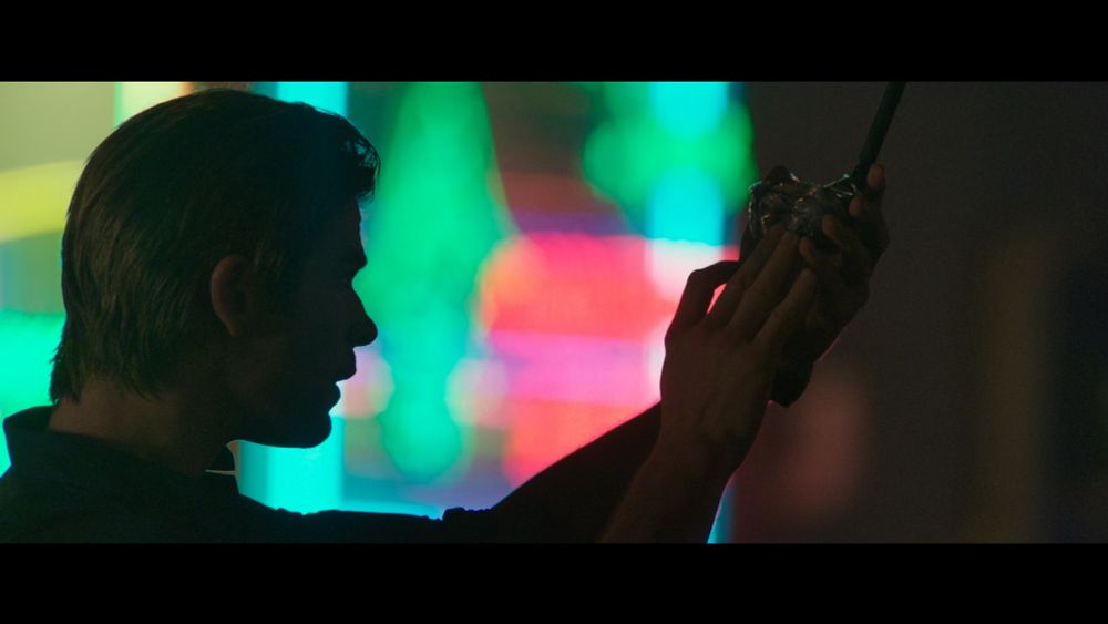 Chris Hemsworth in silhouette bathed in the LED and neon light of Hong Kong in Blackhat (Mann, 2015)