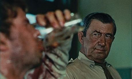 Gary Bond drinking a pint while getting a classic Australian dirty look from Chips Rafferty in WAKE IN FRIGHT (Ted Kotcheff, 1971)