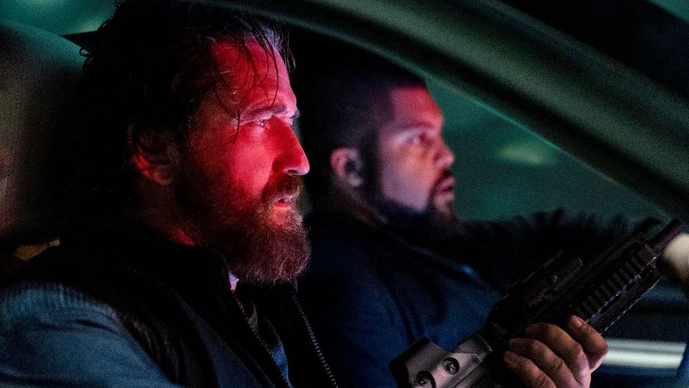 Gerard Butler as Big Nick and O’Shea Jackson Jr. as Donnie behind the wheel of a getaway Porsche in DEN OF THIEVES 2: PANTERA (Christian Gudegast, 2025)