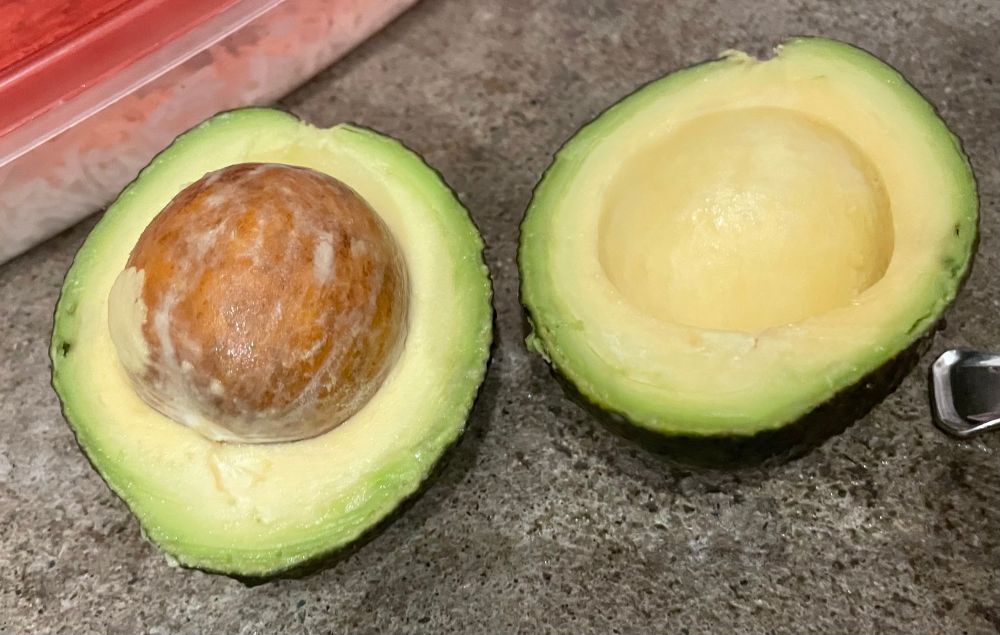 An avocado cut in half with way too much pit. 