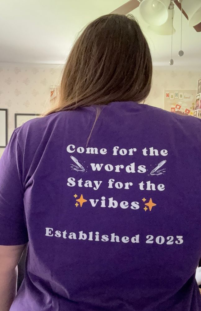 The back of the dark Poole shirt that says Come for the words, stay for the vibes. Established 2023. 