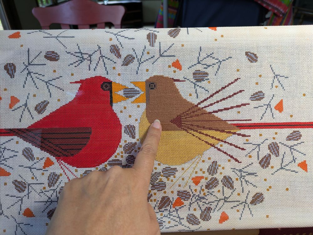 Needlepoint progress. The top segment of the female cardinal is done in a medium brown color called 