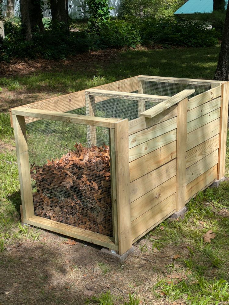 Double compost bin with one side partially filled.