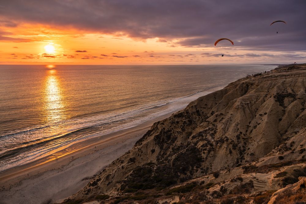 Parachute gliders at sunset at Torrey Pines Cliffs in La Jolla, San Diego, California  