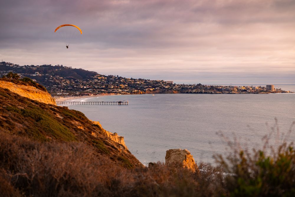 Parachute gliders at sunset at Torrey Pines Cliffs in La Jolla, San Diego, California 