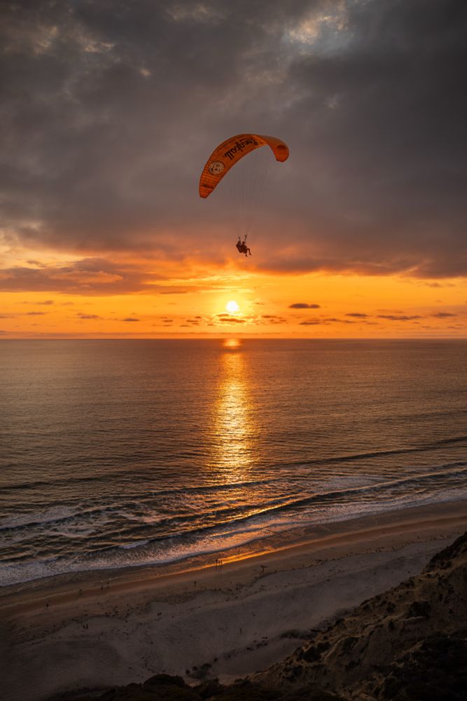 Parachute gliders at sunset at Torrey Pines Cliffs in La Jolla, San Diego, California 