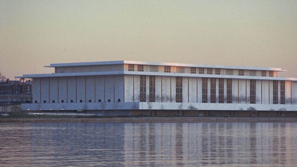 A wide view of the Kennedy Center across water.