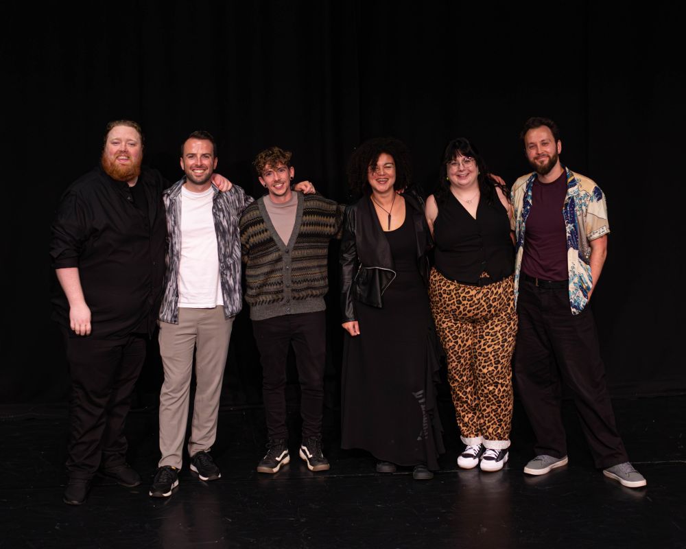 Photo of Abby Oliveira, Gray Crosbie, Shane Strachan, Christie Gourlay, Kevin Mclean, and Jack Hinks standing onstage smiling.