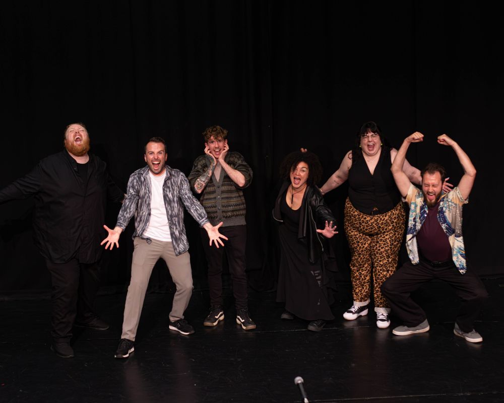 Photo of Abby Oliveira, Gray Crosbie, Shane Strachan, Christie Gourlay, Kevin Mclean, and Jack Hinks standing onstage screaming joyously.