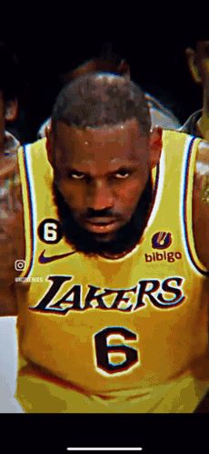 a close up of a basketball player wearing a yellow lakers jersey .