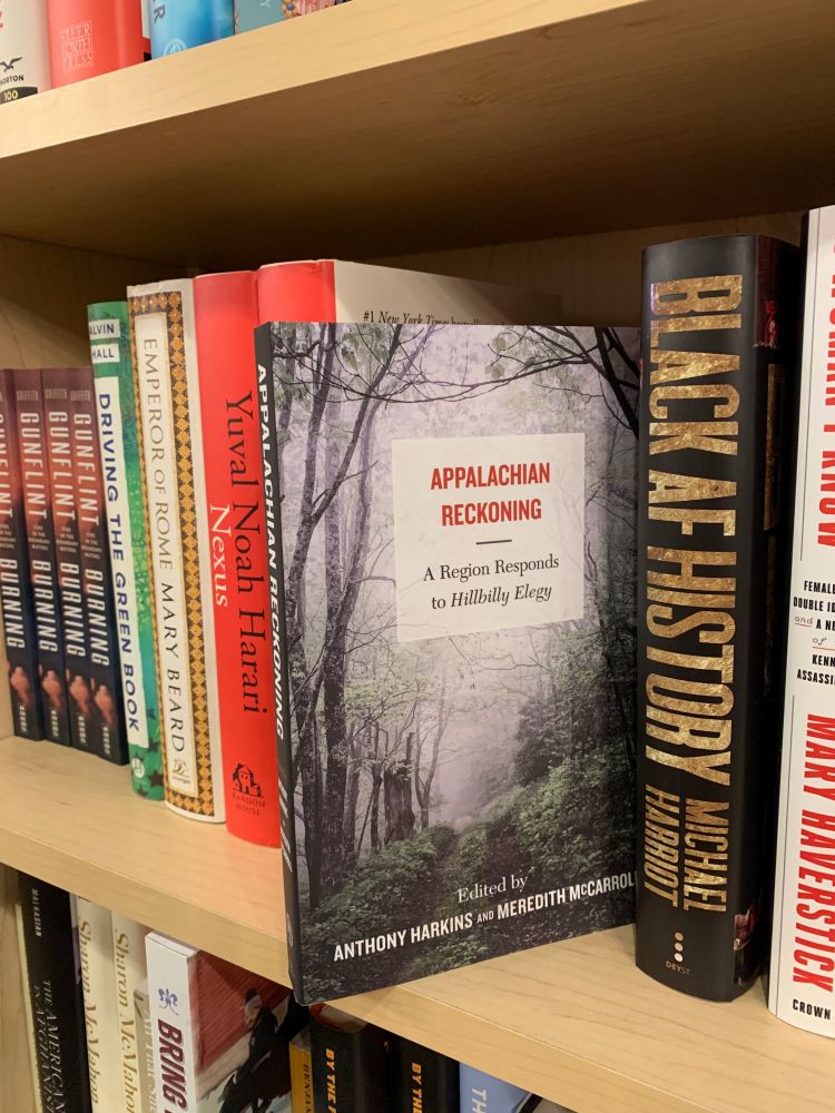 A book on a bookstore shelf titled "Appalachian Reckoning: A Region Responds to Hillbilly Elegy."