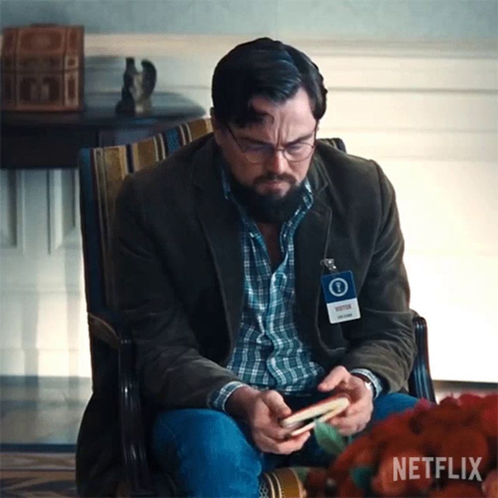 a man sitting in a chair with a name tag that says netflix on it