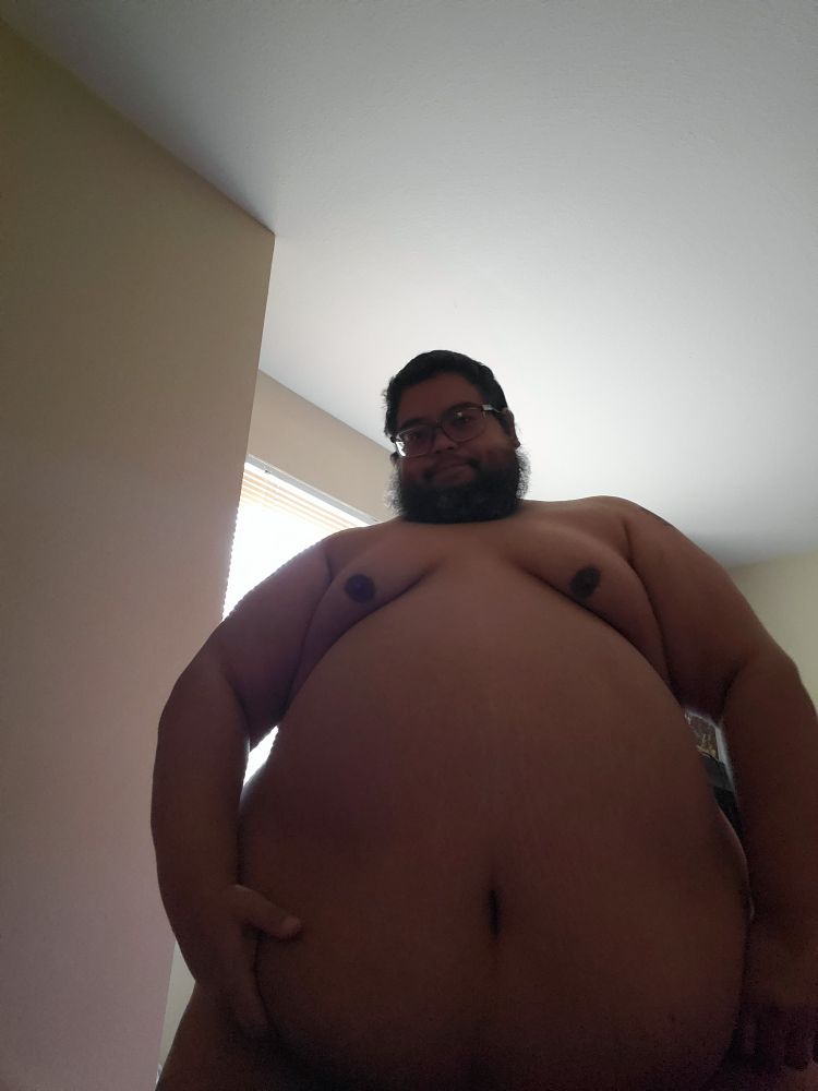 Chubby guy in front of window.