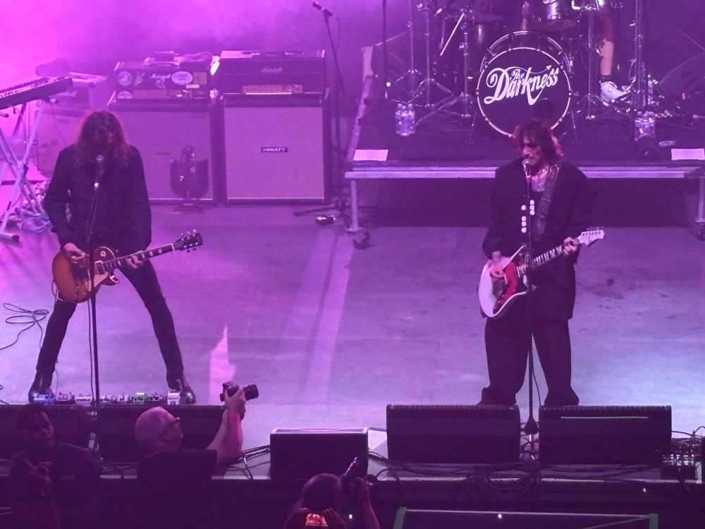Dan and Justin Hawkins of The Darkness playing guitar.
