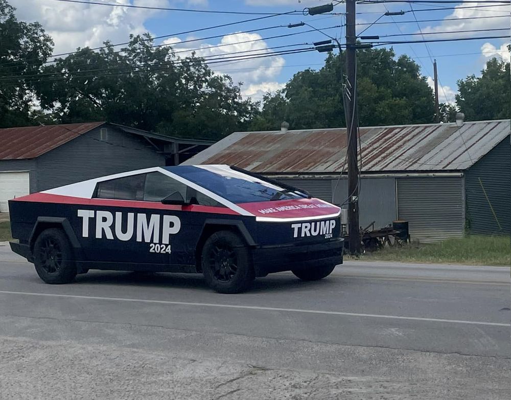a cybertruck with a Trump 2024 wrap on it