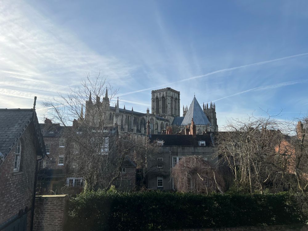 York Minster, peeking out above some houses, as seen from the city walls.