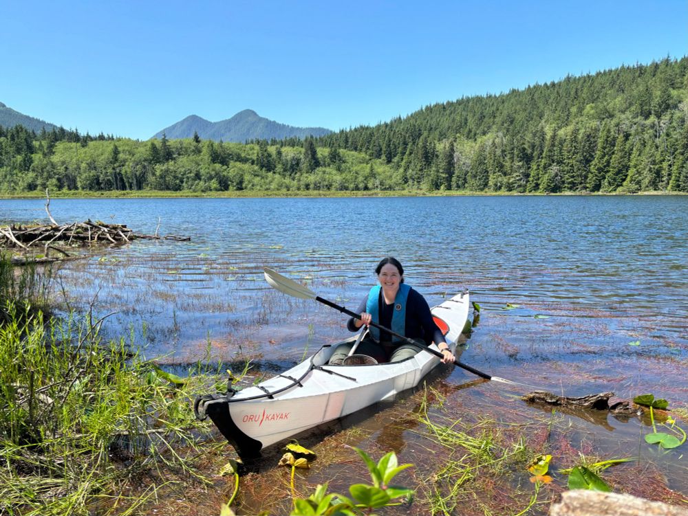 Research intern sampling fish from kayak