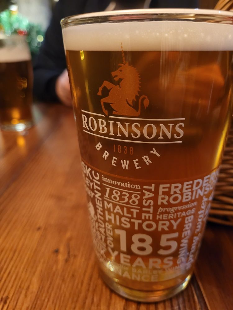 A pint of Dizzy Blonde pale ale on a pub table.