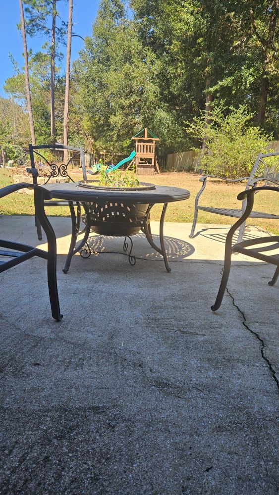 Fire table with middle insert removed and large garden pot on a riser in the middle