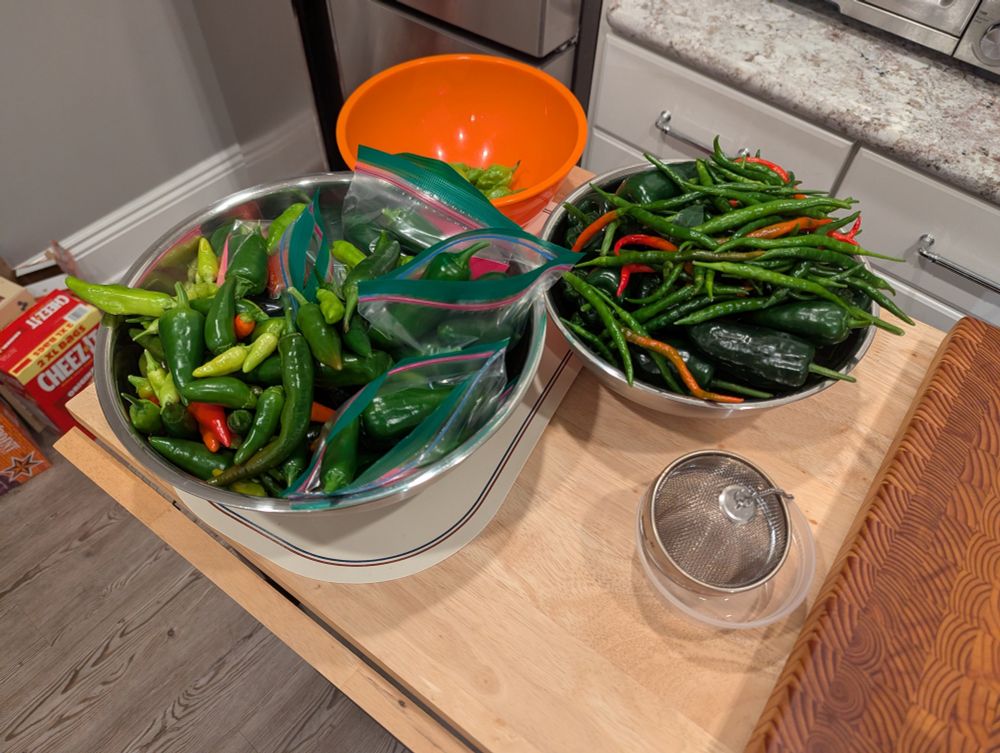 Two bowls filled with peppers.