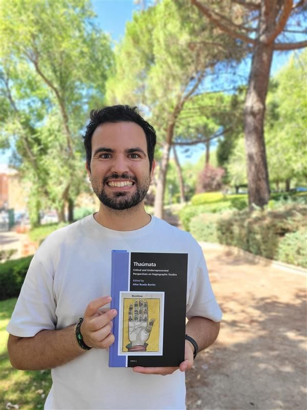  Editor holding a copy of the book Thaumata: Critical and Underrepresented Perspectives on Hagiographic Studies 