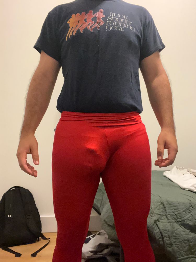Me wearing red tights with my chastity cage visibly bulging through the front 
