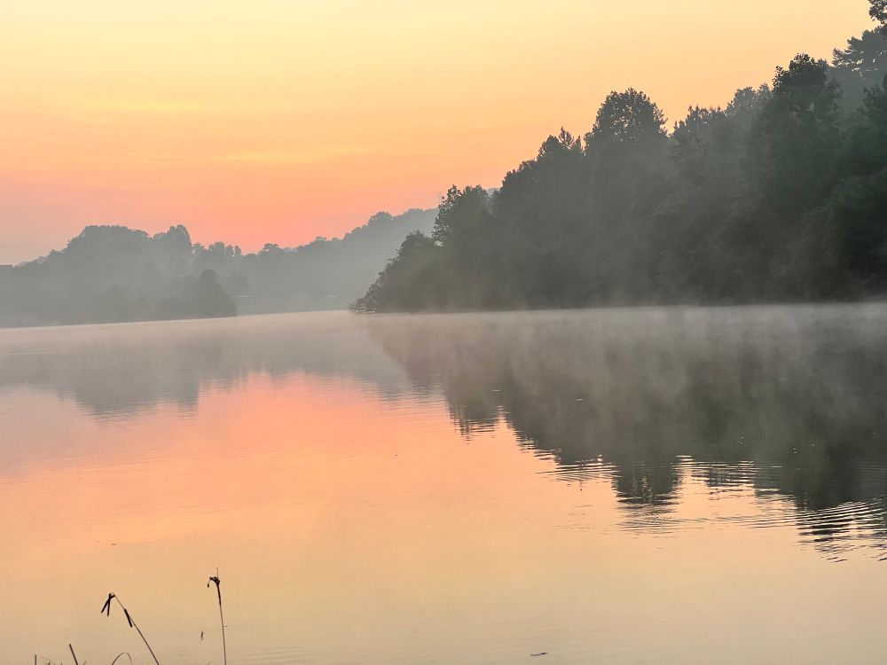 Sunrise over a foggy lake. 
